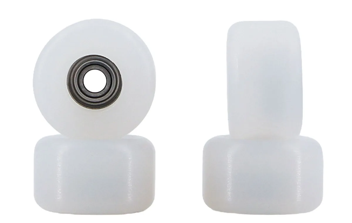 Four white Sunpower High Riderz wheels in two stacks. On the left, the top wheel faces the camera, showing its round face and the bearing in the middle. On the right, the top wheel stands on its edge, showing how wide it is.